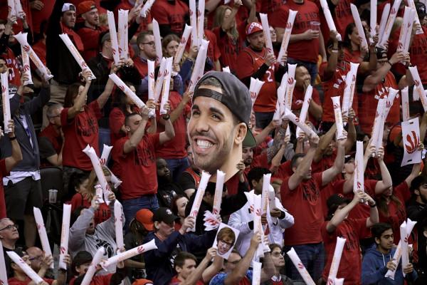 Toronto Raptors fans hold up a photo of Toronto-born performer Aubrey "Drake" Graham during first half NBA Eastern Conference finals action in Toronto on Saturday, May 25, 2019. THE CANADIAN PRESS/Frank Gunn