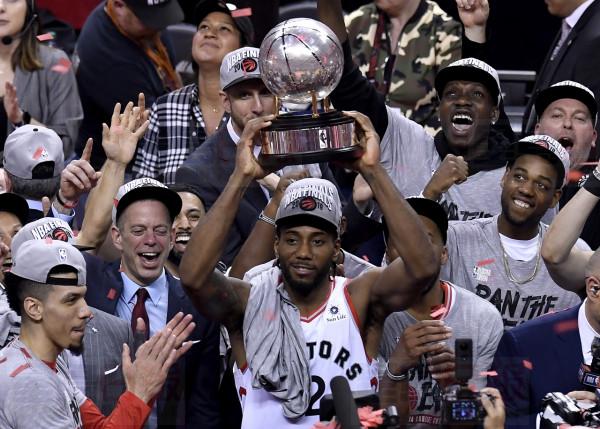 Toronto Raptors forward Kawhi Leonard (2) holds up the trophy after the team's 100-94 game six win over the Milwaukee Bucks to become the NBA Eastern Conference champions, in Toronto on Saturday, May 25, 2019. THE CANADIAN PRESS/Frank Gunn