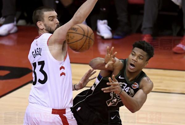 Toronto Raptors centre Marc Gasol (33) looks on as Milwaukee Bucks forward Giannis Antetokounmpo (34) sends the pass during first half NBA Eastern Conference finals action in Toronto on Saturday, May 25, 2019. THE CANADIAN PRESS/Frank Gunn