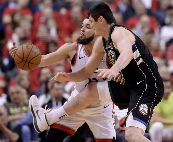 Milwaukee Bucks forward Ersan Ilyasova (77) and Toronto Raptors guard Fred VanVleet (23) vie for control of the ball during second half NBA Eastern Conference finals action in Toronto on Saturday, May 25, 2019. THE CANADIAN PRESS/Nathan Denette