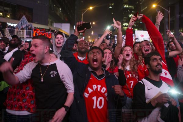 Toronto Raptors fans celebrate in the closing seconds of the team's 100-94 win over the Milwaukee Bucks to take the NBA Eastern Conference Championship, in Toronto on Saturday, May 25, 2019. The Raptors go to the NBA final for the first time in the franchise's history. THE CANADIAN PRESS/Chris Young