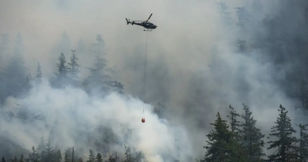 An aerial crew works on the Dryden Creek fire, an a out-of-control wildfire, just north of Squamish, B.C., on Tuesday, June 10, 2025. THE CANADIAN PRESS/Tijana Martin